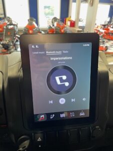 Touch screen of Segway UT6 Utility Vehicle displaying music being played